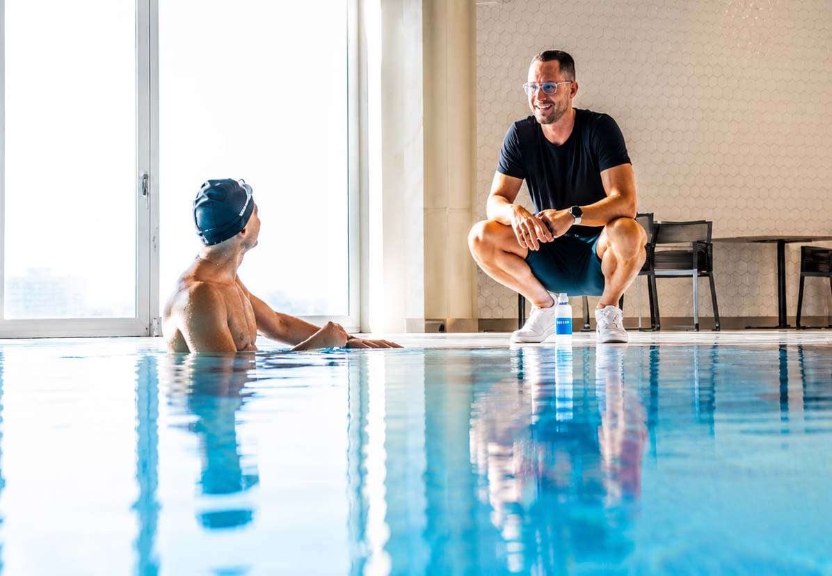 Coach providing private one-on-one swim coaching at the pool