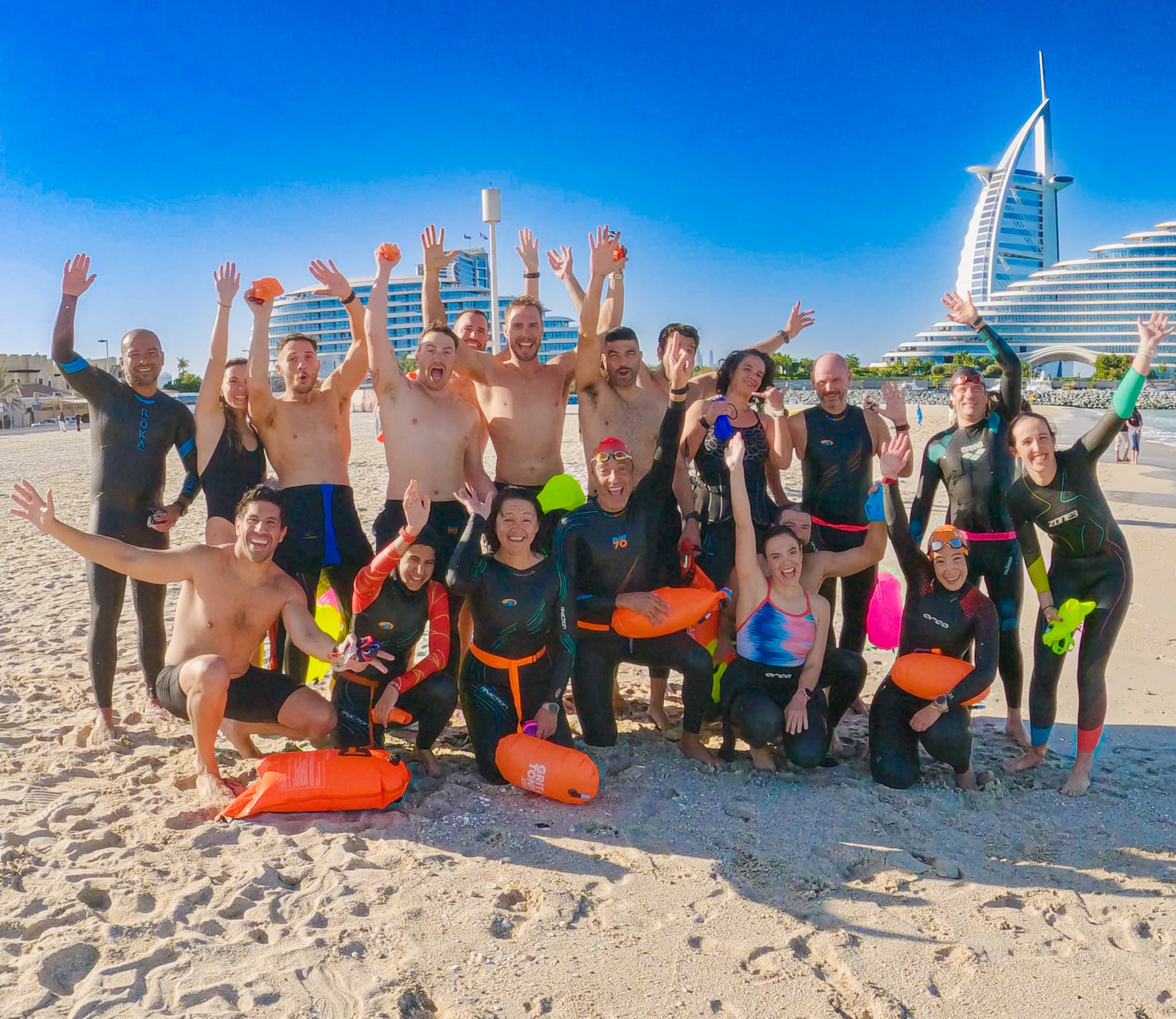 SwimFast athletes gathered on the beach after an open water swim in Dubai
